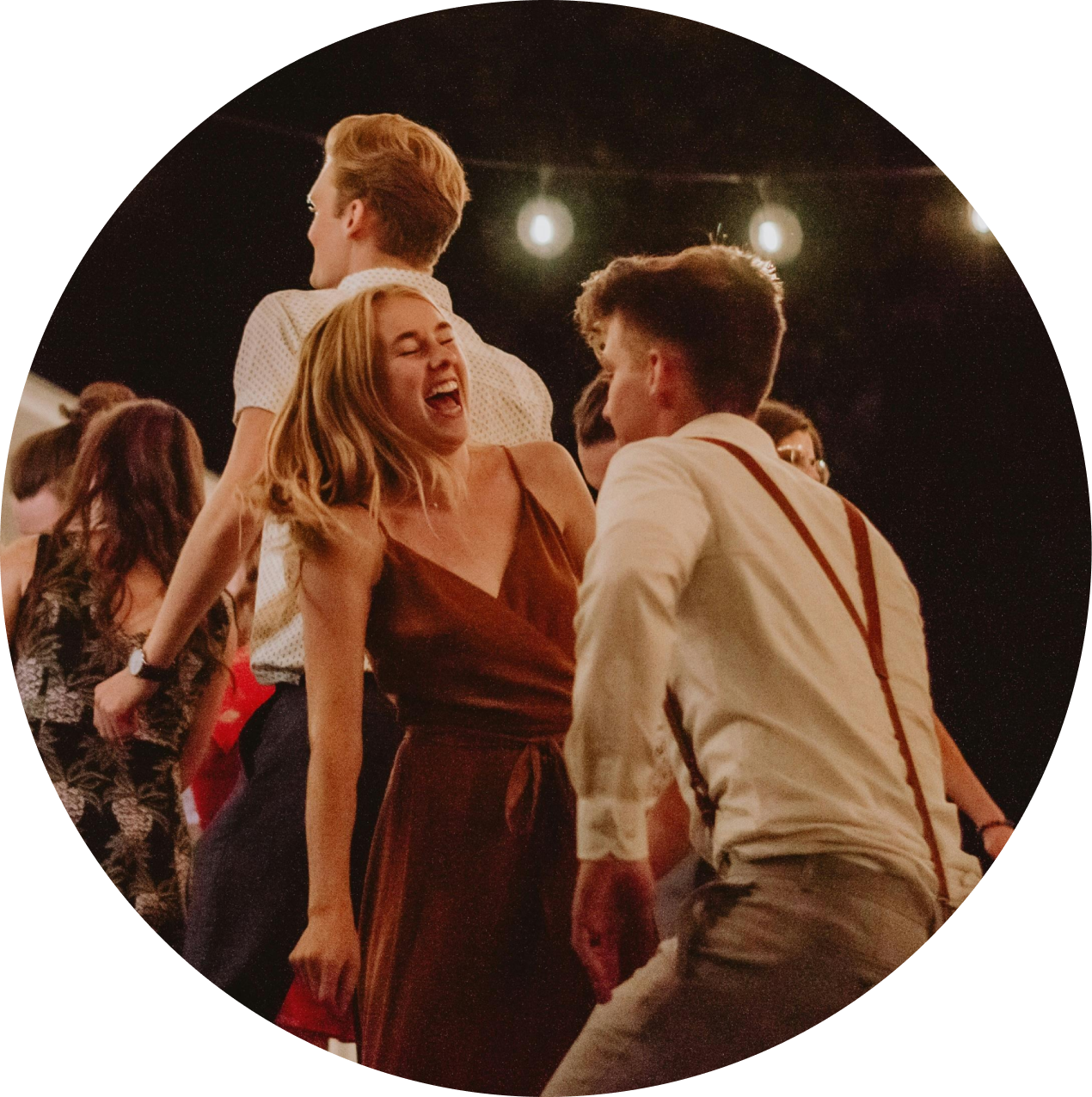 rounded photo of a crouded party with colorful lighting